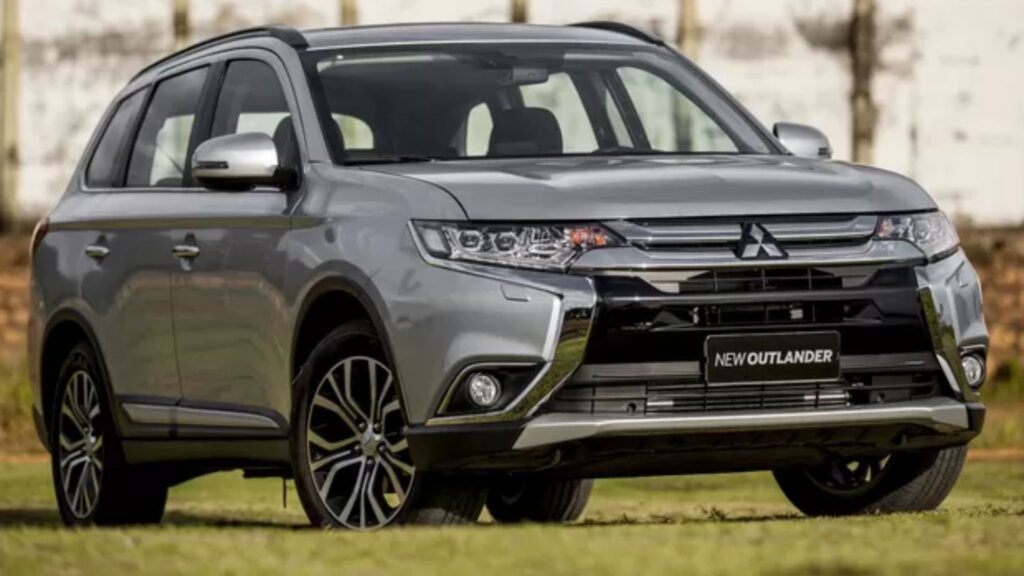 Mitsubishi OUTLANDER 2016 cinza na diagonal em cima de uma gramado.