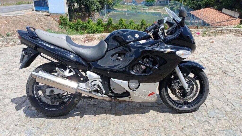 SUZUKI GSX 750 F 2008 preta de lado parada no meio da estrada.